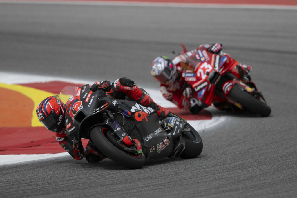 Maverick Vinales (12) leads Enea Bastianini (23) in Portugal. Photo courtesy Aprilia.