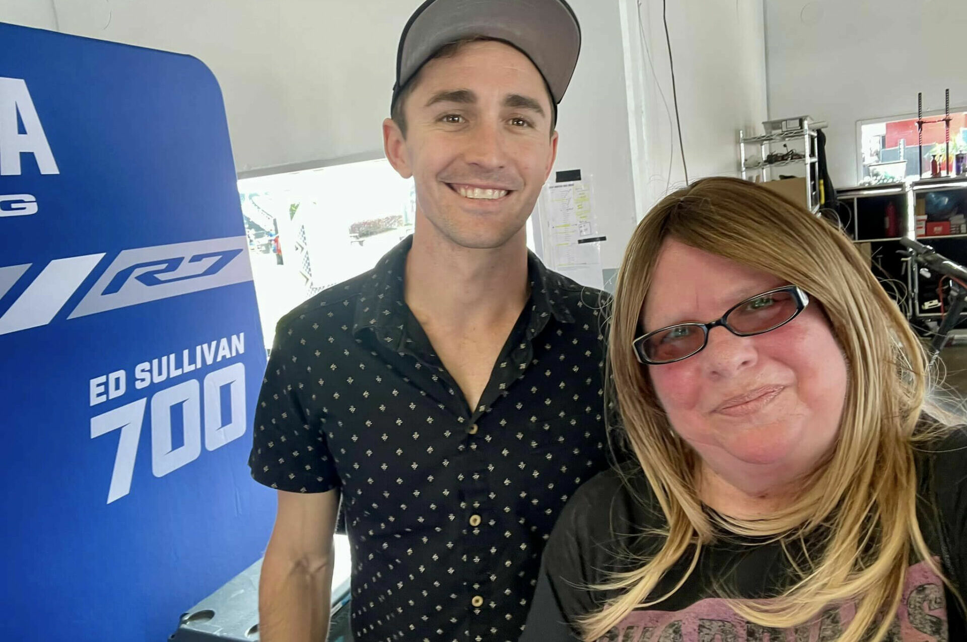 Mathew Scholtz with longtime racing official Diane Shepard Tribou in the garage of Ed Sullivan, Scholtz's longtime crew chief who is competing in MotoAmerica Twins Cup at Daytona on his SE Composites Yamaha YZF-R7. Photo courtesy Diane Shepard Tribou.