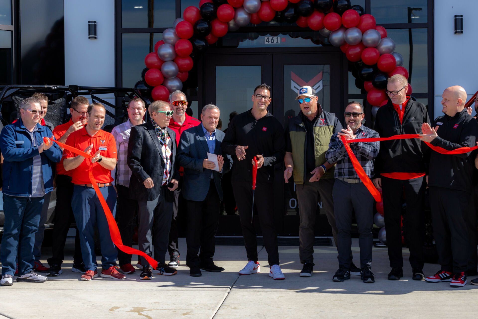 Rad Gladfelder (center holding red scissors), the General Manager of Young Honda Powerhouse, cuts the ribbon at the grand opening of Utah's newest powersports dealership. Photo courtesy Young Automotive Group.