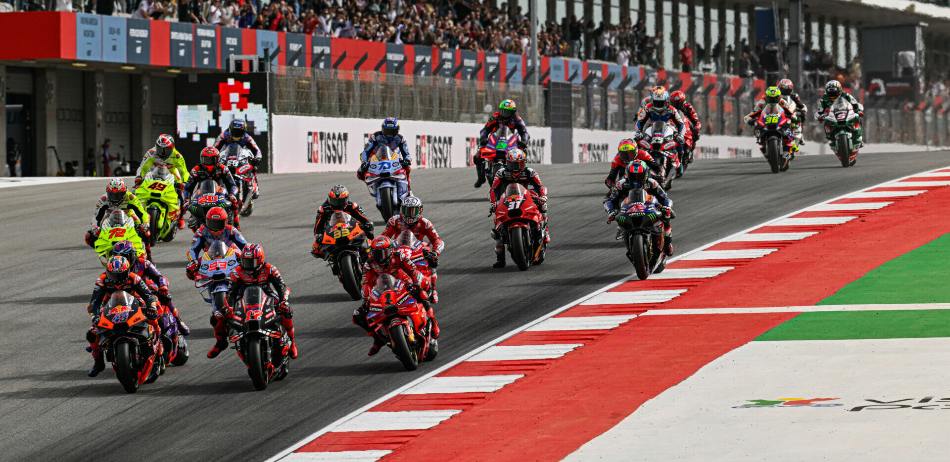 Jack Miller (43), Maverick Vinales (12), and Francesco Bagnaia (1) fight for the lead into Turn One at the start of Saturday's MotoGP Sprint Race in Portugal. Photo courtesy Dorna.