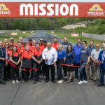 Mission Foods CEO Juan Gonzalez (center in white shirt) cuts a ribbon dedicating the new Mission Bridge and #2Fast2Tasty Beach viewing area at Road America. Photo courtesy Road America.