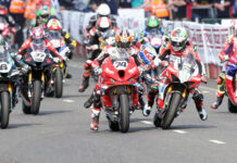 Glenn Irwin (1) and Davey Todd (74) nearly touch as they launch off the grid at the North West 200. Photo courtesy NW200 Press Office.