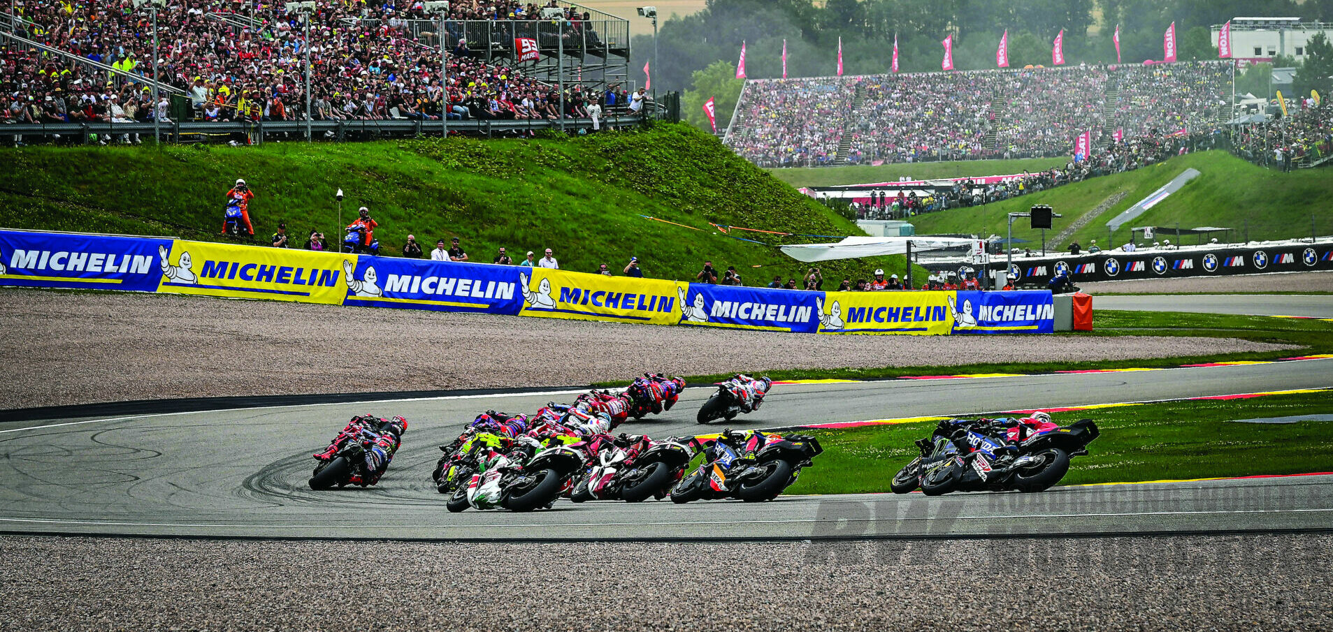Trackhouse Racing’s Miguel Oliveira leads the first lap of a MotoGP race at the Sachsenring, in Germany, riding a 2024 Aprilia RS-GP. Photo by Gigi Soldano/DPPI Media.  