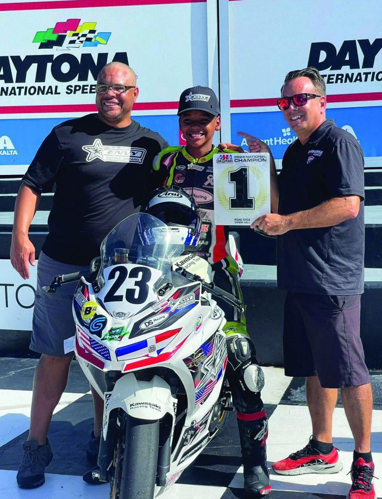 Derek Sanchez (center) on the podium during the 2024 ASRA Race of Champions at Daytona with supporters Darwin Rodriguez (left) and Jason Routhier (right). Photo courtesy Derek Sanchez.