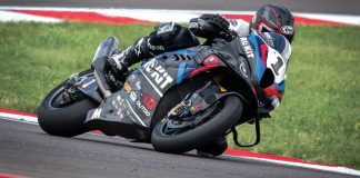 Sam Fleming on Toprak’s World Superbike. Note the cups on the axles for the quick change wheels to enable the team to leave the tires in the warmer ovens until the last possible second before the bike goes onto the track, the finned front calipers with dry-break lines, and lots and lots of radiator.