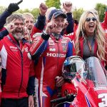 The Honda Racing team and Dean Harrison celebrating his victory at the Isle of Man TT.