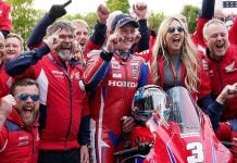 The Honda Racing team and Dean Harrison celebrating his victory at the Isle of Man TT.