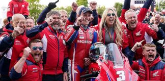 The Honda Racing team and Dean Harrison celebrating his victory at the Isle of Man TT.