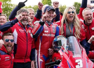The Honda Racing team and Dean Harrison celebrating his victory at the Isle of Man TT.