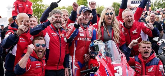 The Honda Racing team and Dean Harrison celebrating his victory at the Isle of Man TT.