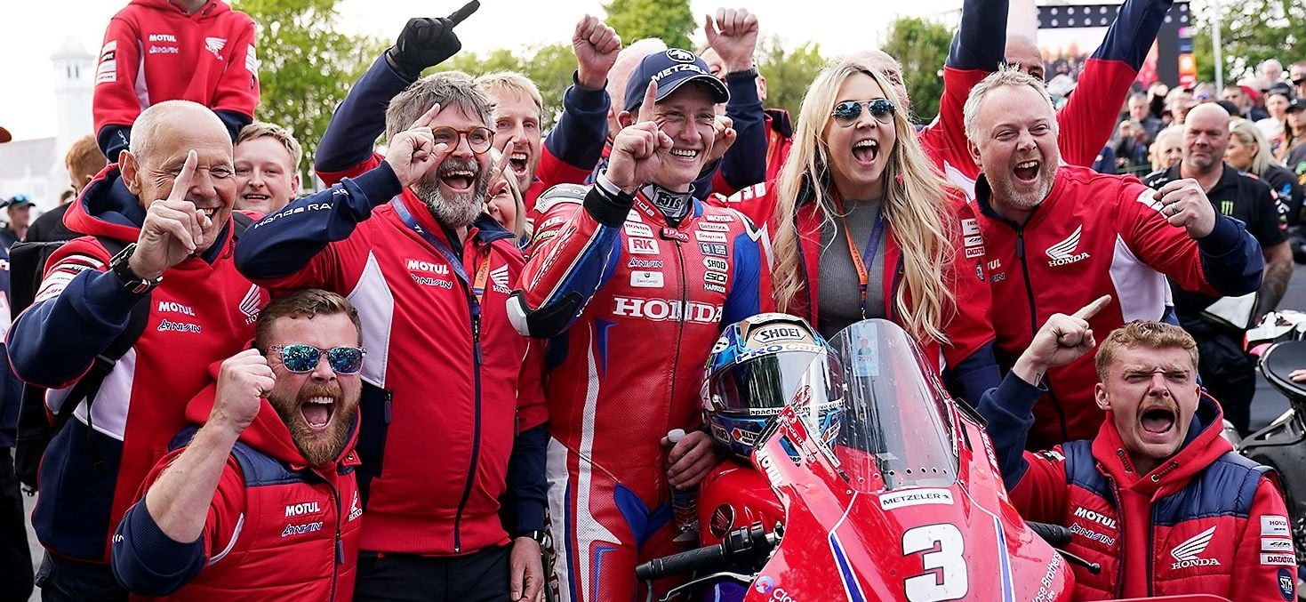 The Honda Racing team and Dean Harrison celebrating his victory at the Isle of Man TT.
