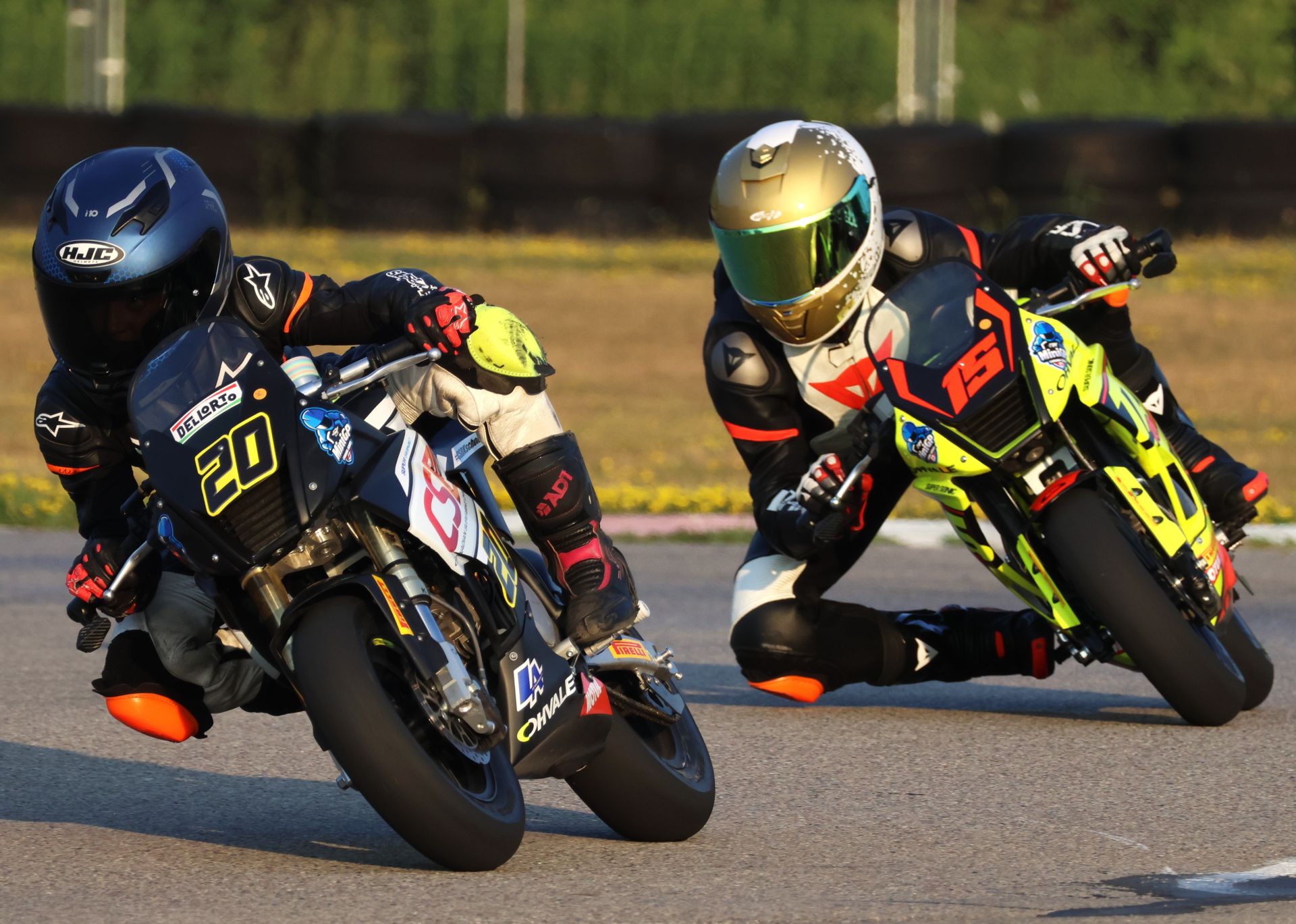 The No. 20 Bridgestone CSBK Scholarship Ohvale entry of Martina Cardenas (age 10) of Maple Ridge, B.C., leads the No. 15 TAS Racing Ohvale of rookie Stefan Tanasic (age 14) onto the front straight at Brechin Motorsports Park during practice for round one of the Motul MiniGP Nationals.