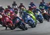 Riders charge into the first corner during a MotoGP race. Photo courtesy Dorna.