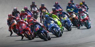 Riders charge into the first corner during a MotoGP race. Photo courtesy Dorna.