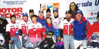 1993 Formula USA Feature race podium on Halloween at Road Atlanta, GA, with the Barely Human entered Yamaha effort of Fast Company and associates (Left to Right): Fred Burchill, Trevor Weiles (eventual factory Honda USA race Tech), Peter Newfeld, builder Scott Miller (Class of 2025), Fred Kling, Tina Kling, Rob Stoeser, rider (the late) Fritz Kling, bike owner Doc Mark Brubacher, EBC Brakes Rep Gary Gallagher. (Chuck Graves in hat with Suzuki to left and the late Mike Velasco on Sadowski Honda to right). Photo by Colin Fraser.