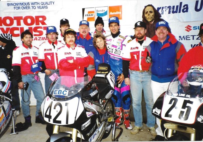 1993 FUSA Podium Halloween Road Atlanta GA WERA GNFs C Graves F Kling D Sadowski by CF Oct 1993 Formula USA Feature race podium on Halloween at Road Atlanta, GA, with the Barely Human entered Yamaha effort of Fast Company and associates (Left to Right): Fred Burchill, Trevor Weiles (eventual factory Honda USA race Tech), Peter Newfeld, builder Scott Miller (Class of 2025), Fred Kling, Tina Kling, Rob Stoeser, rider (the late) Fritz Kling, bike owner Doc Mark Brubacher, EBC Brakes Rep Gary Gallagher. (Chuck Graves in hat with Suzuki to left and the late Mike Velasco on Sadowski Honda to right). Photo by Colin Fraser.