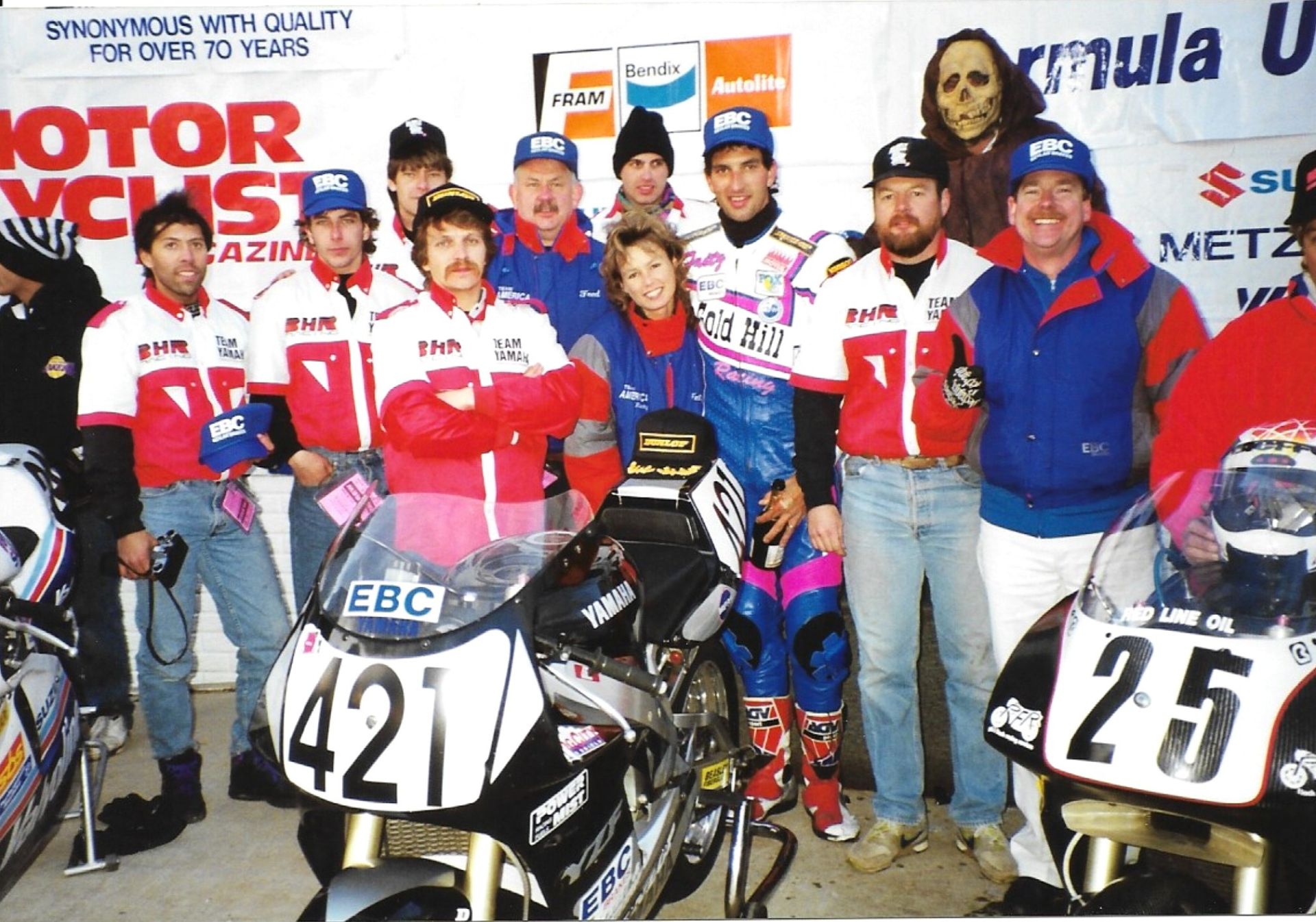 1993 Formula USA Feature race podium on Halloween at Road Atlanta, GA, with the Barely Human entered Yamaha effort of Fast Company and associates (Left to Right): and Fred Burchill, Trevor Weiles (eventual factory Honda USA race Tech), Peter Newfeld, builder Scott Miller (Class of 2025), Fred Kling, Tina Kling, Rob Stoeser, rider (the late) Fritz Kling, bike owner Doc Mark Brubacher, EBC Brakes Rep Gary Gallagher. (Chuck Graves in hat with Suzuki to left and the late Mike Velasco on Sadowski Honda to right). Photo by Colin Fraser.