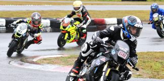 Race one of three, lap one, in the wet Motul FIM MiniGP Canada round two at Le Circuit Mont Tremblant in Quebec, and eventual triple winner No. 68 Jager Stockill, No. 91 Ethan Reardon, No. 15 Stefan Tanasic and No. 20 Martina Cardenas. Eventually earning third, Cardenas made history as the first female to earn the podium at a Mini National round. Photo courtesy Colin Fraser.