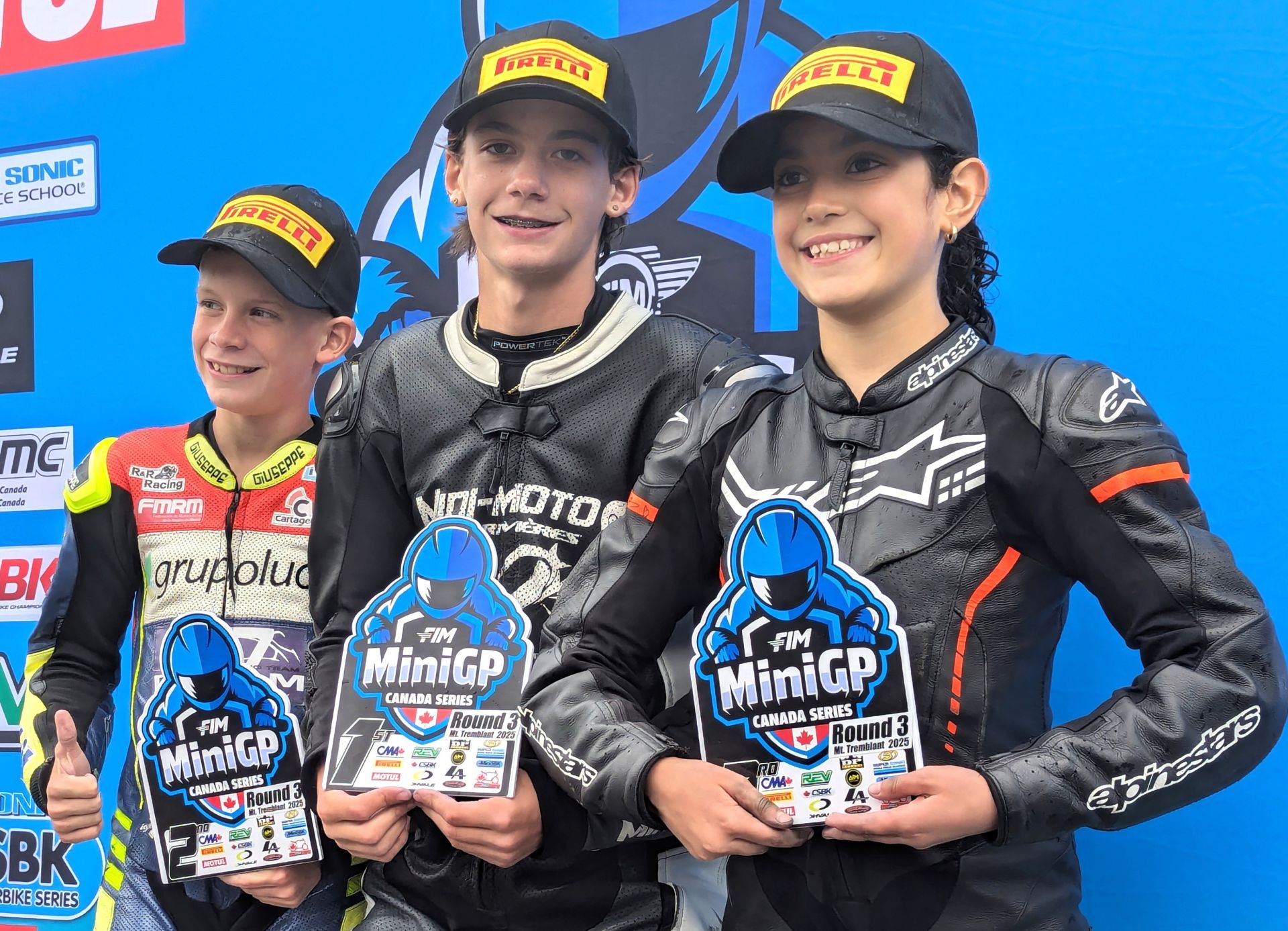 Podium for race three of three at the Motul MiniGP FIM Canadian National in Quebec with (left to Right) runner up Ethan Reardon, victor Jager Stockill and third placed Martina Cardenas – her second Podium effort of the rainy day. Photo courtesy Colin Fraser.