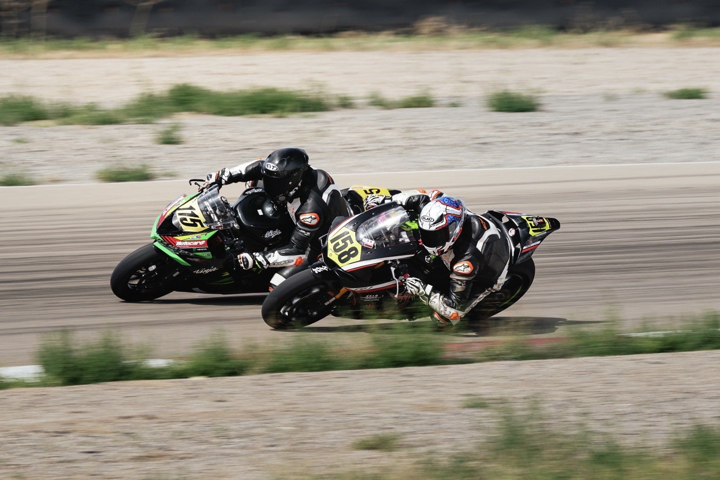 Derek Festavan (115) trying to pass James Walker (158) in stock1000 Novice race. Photo by Richard Jellerson.
