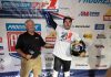 Dallas Daniels (32) celebrates after receiving his Championship #1 plate from Mike Burkeen (American Motorcyclist Association) at Lake Ozark Speedway Saturday night. Photo by Tim Lester / courtesy American Flat Track.