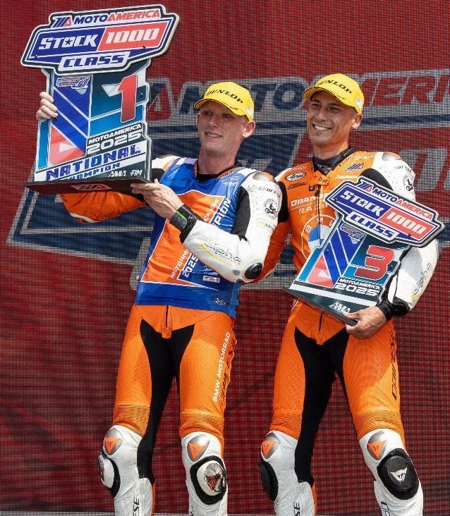 OrangeCat Racing riders Andrew Lee (left) and Jayson Uribe pose in victory circle at the Circuit of the Americas in Austin, Texas, on Sunday after clinching first place and third place, respectively, in the 2025 MotoAmerica Stock 1000 Championship. Photo credit: Brian J. Nelson