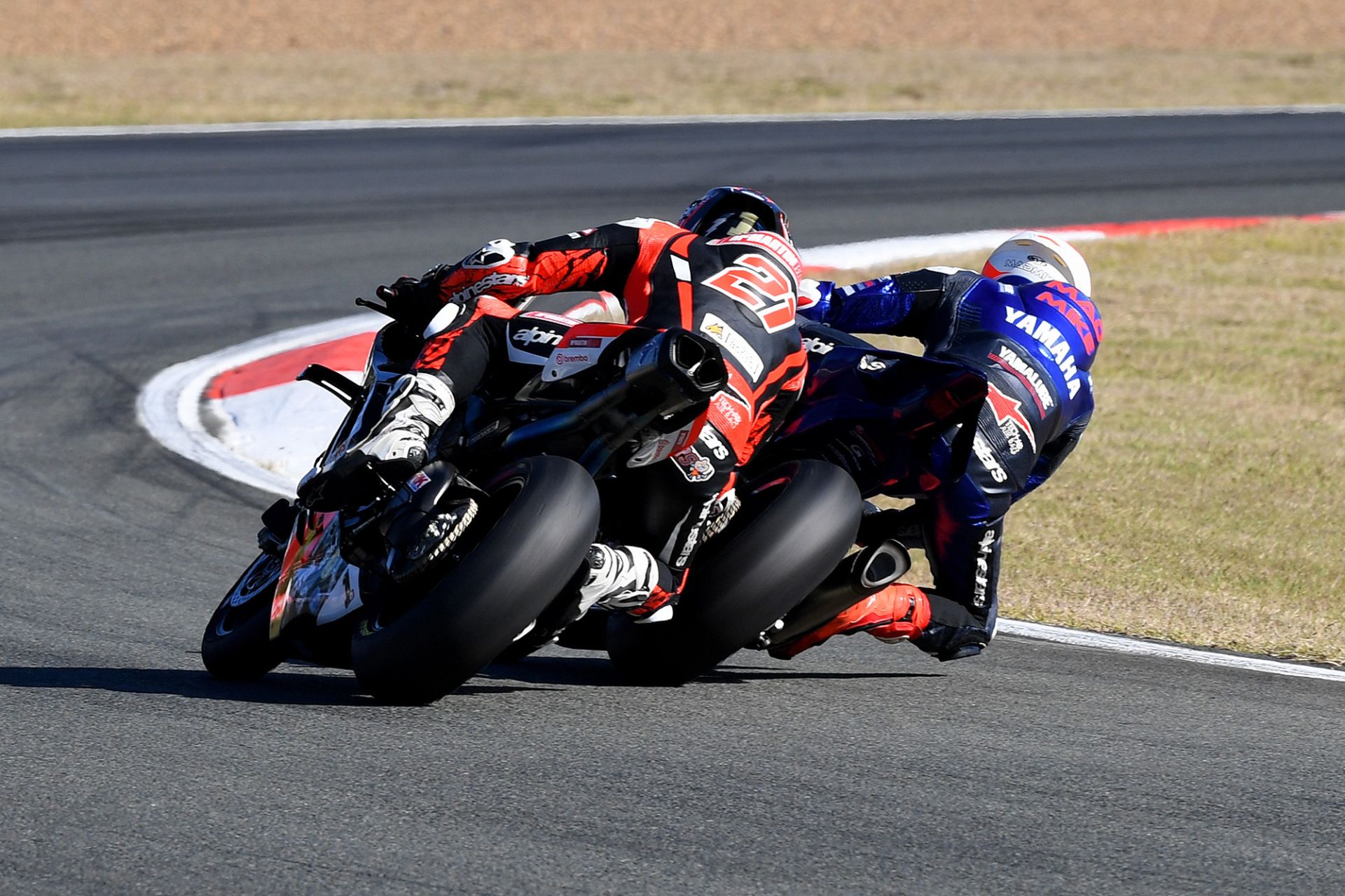Mike Jones slips up the inside of Josh Waters in a thrilling battle at Queensland Raceway. Photo by Russell Colvin