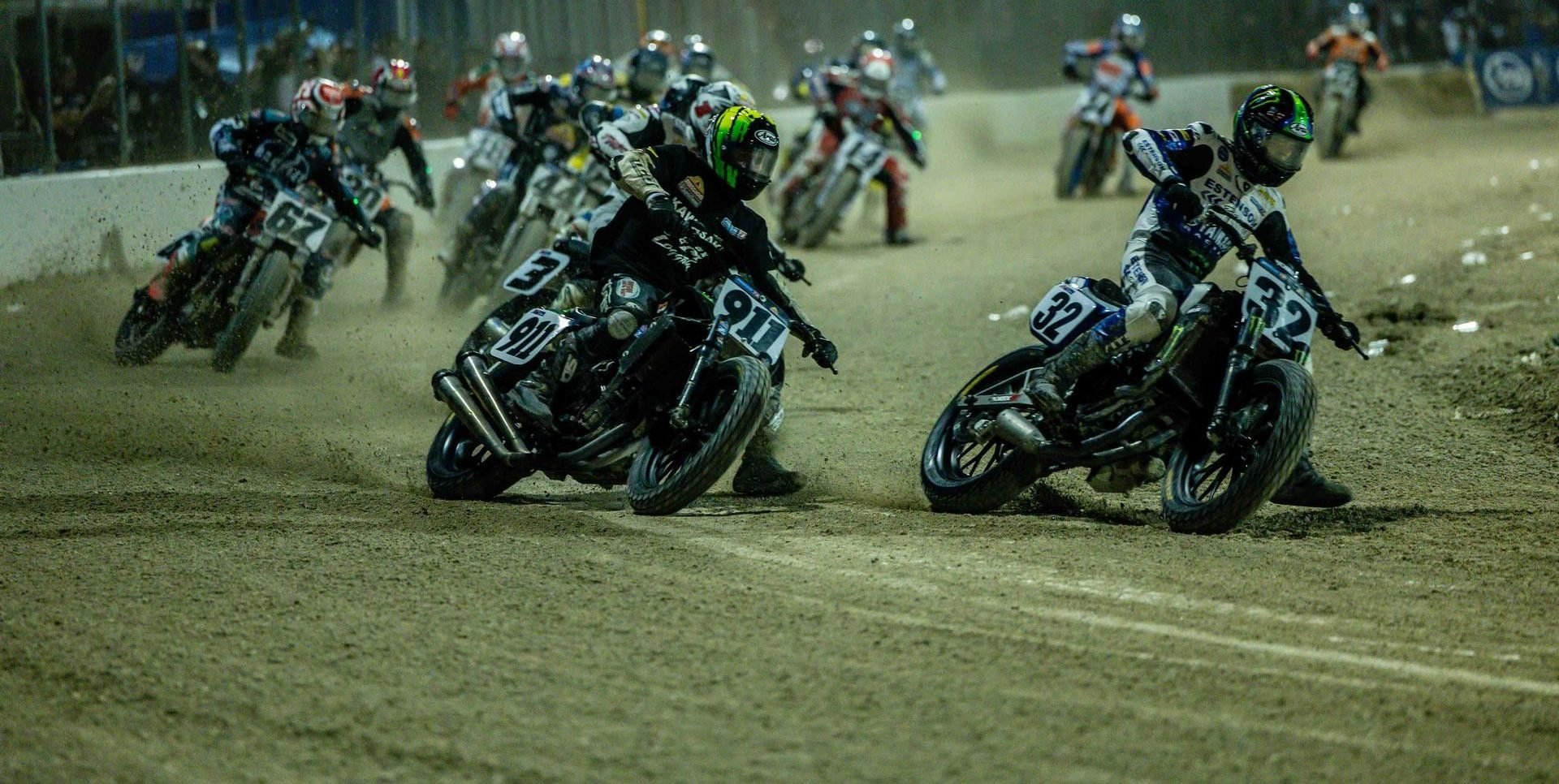Mission AFT SuperTwins riders Dallas Daniels (32), Henry Wiles (911), Briar Bauman (3), Davis Fisher (67), and others race during the Round Two Main Event at the 2025 Daytona Short Track II. Photo by Tim Lester / courtesy American Flat Track.