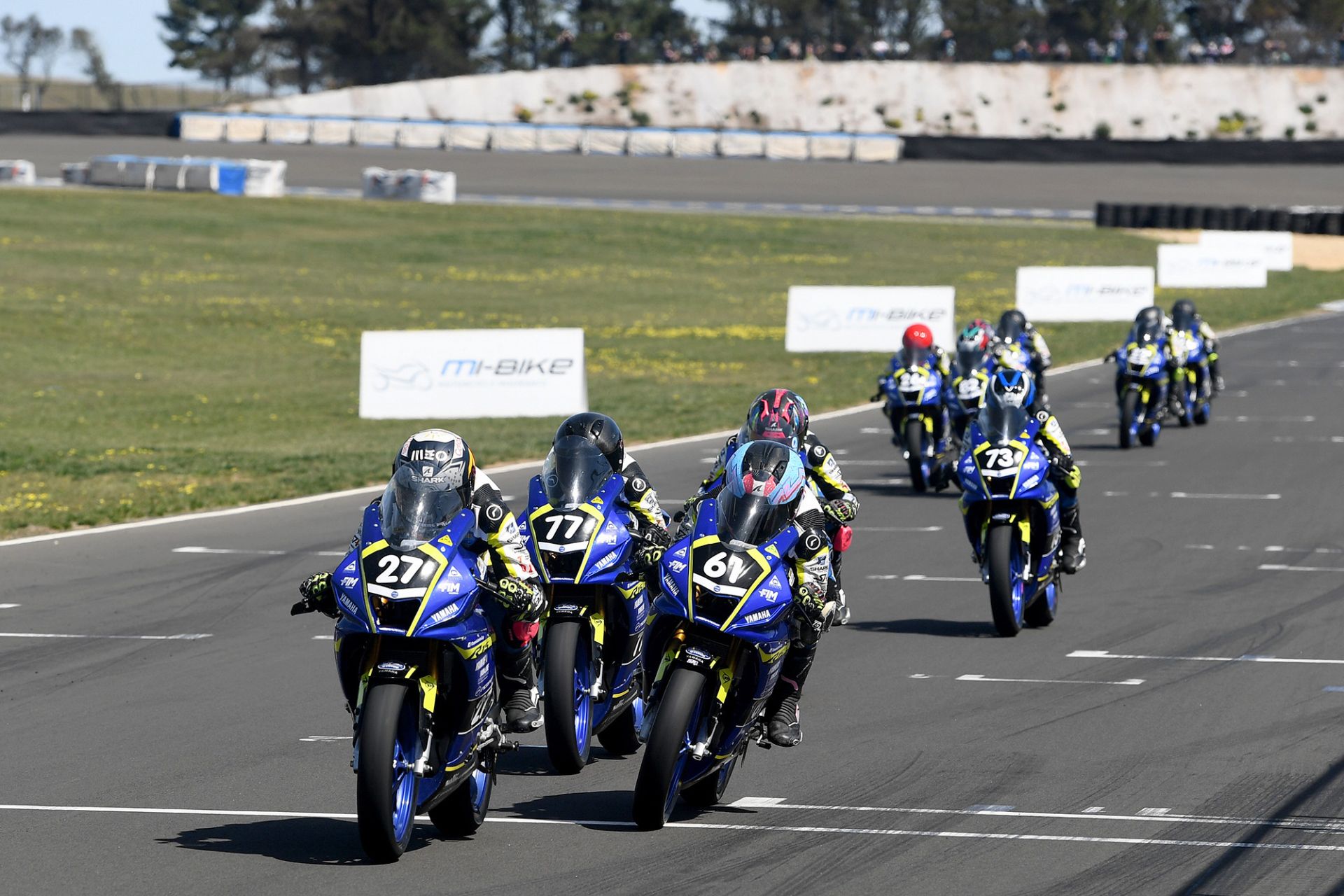 Plowman (#27), McAdam (#61) and Rossi (#77) flash across the finish line in the OJC opener. Image: Russell Colvin